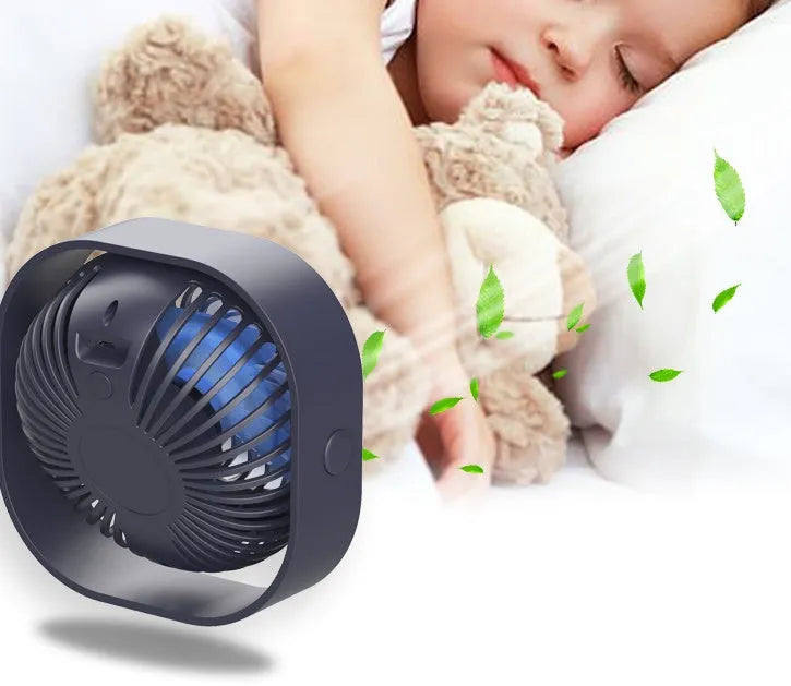Compact USB desk fan in blue with 360-degree rotation head and rotary switch.