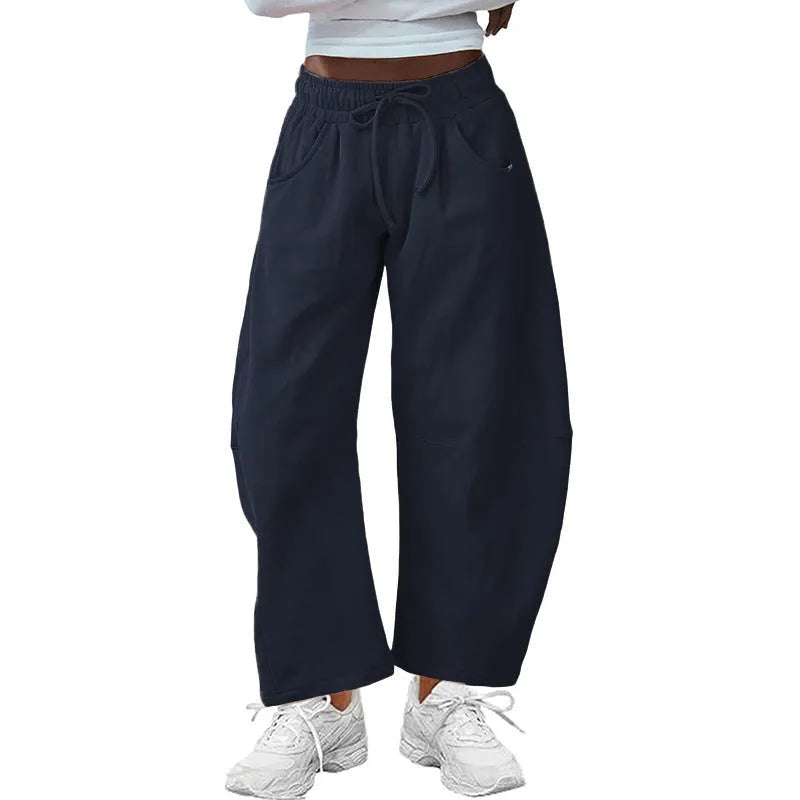 Loose cropped sweatpants with drawstring waist and side pockets in street fashion styling