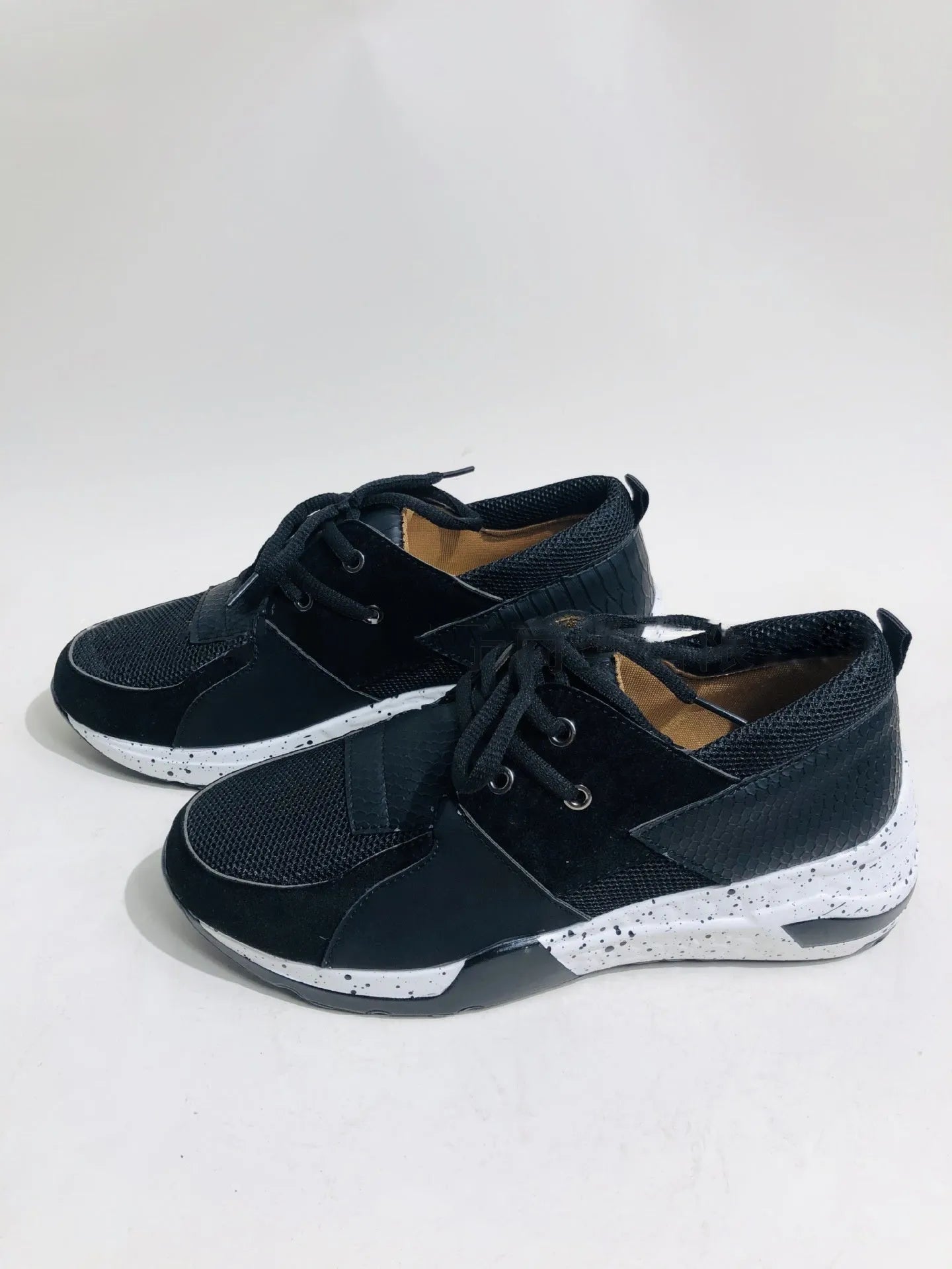 Women's casual suede sneakers with a wedge heel in black, leopard, pink, and snake pattern colours.