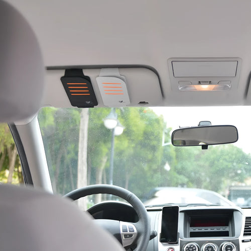 Set of four grey car sun visor shading panels next to a vehicle-mounted storage bag.