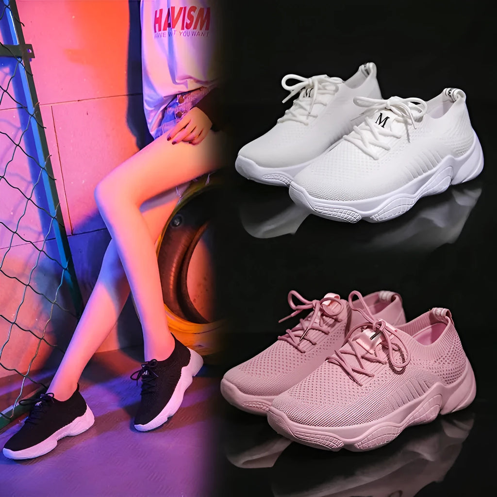 Women's white low-top woven sneakers with thick rubber sole and elastic front strap.