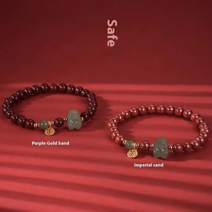 Handmade Hetian jade bracelet with cinnabar inlay showing 8mm beads and animal zodiac modelling