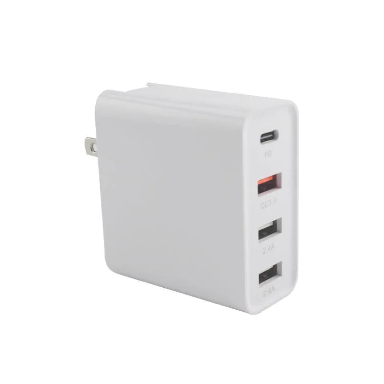 Black and white four-port USB-C wall charger with interchangeable UK, US, EU, and AU plug heads.