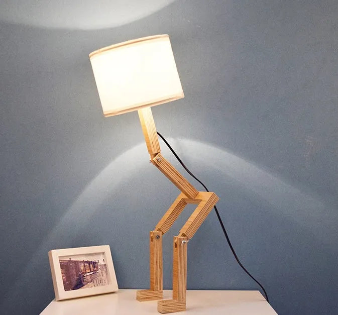 Creative wooden humanoid table lamp with white fabric shade, deformable design, 22x44x16cm