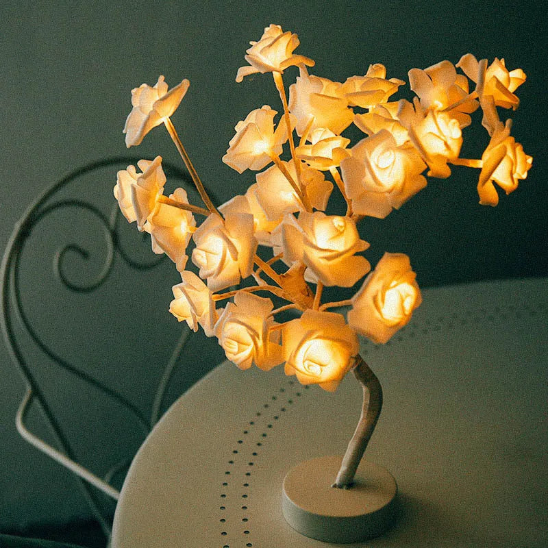 White and red rose flower LED table lamp with bonsai tree lights on a table.