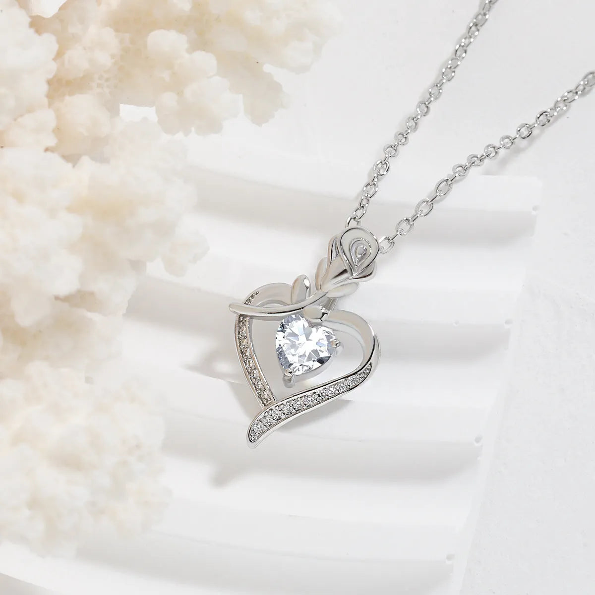 Rose heart-shaped necklace with rhinestones in copper electroplated finish, available in blue, purple, red, or white