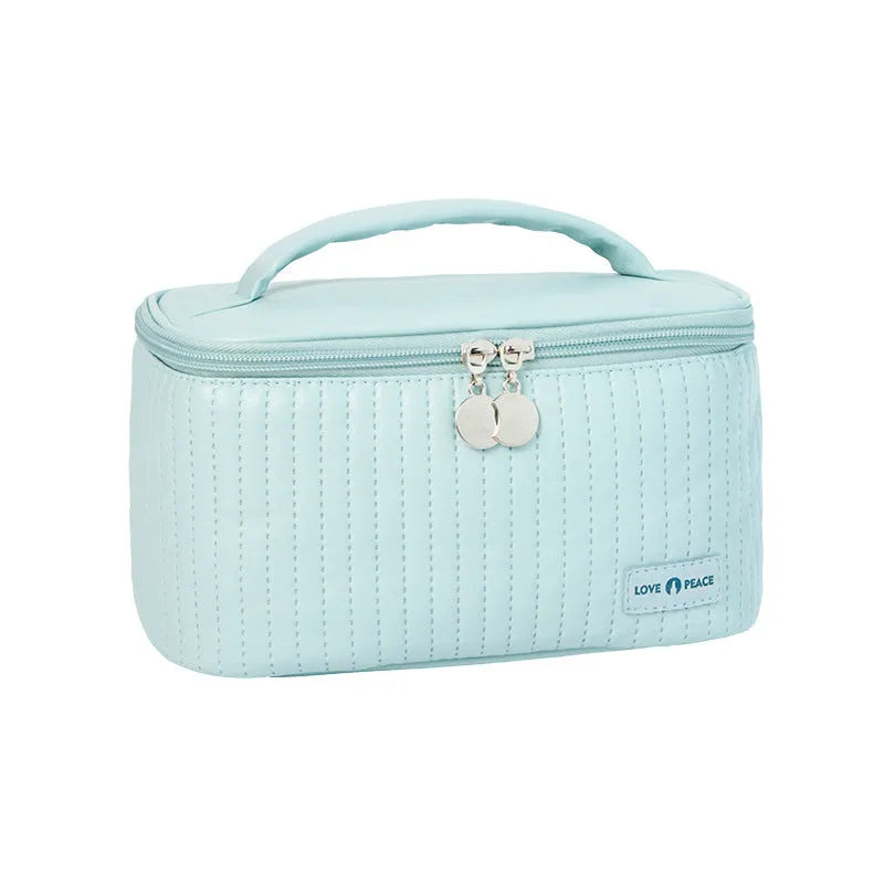 Open-top cake-shaped women's makeup bag in PU leather, shown in a soft solid colour.