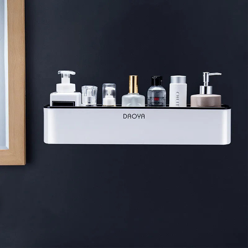 Wall mounted plastic bathroom shelf with polished finish holding shampoo and shower gel bottles