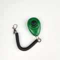 Plastic dog training clicker in black with wrist strap on white background