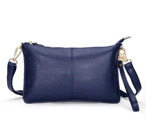 Lady's cowhide leather slant bag in apricot colour with hand strap and shoulder strap showing zipper compartments
