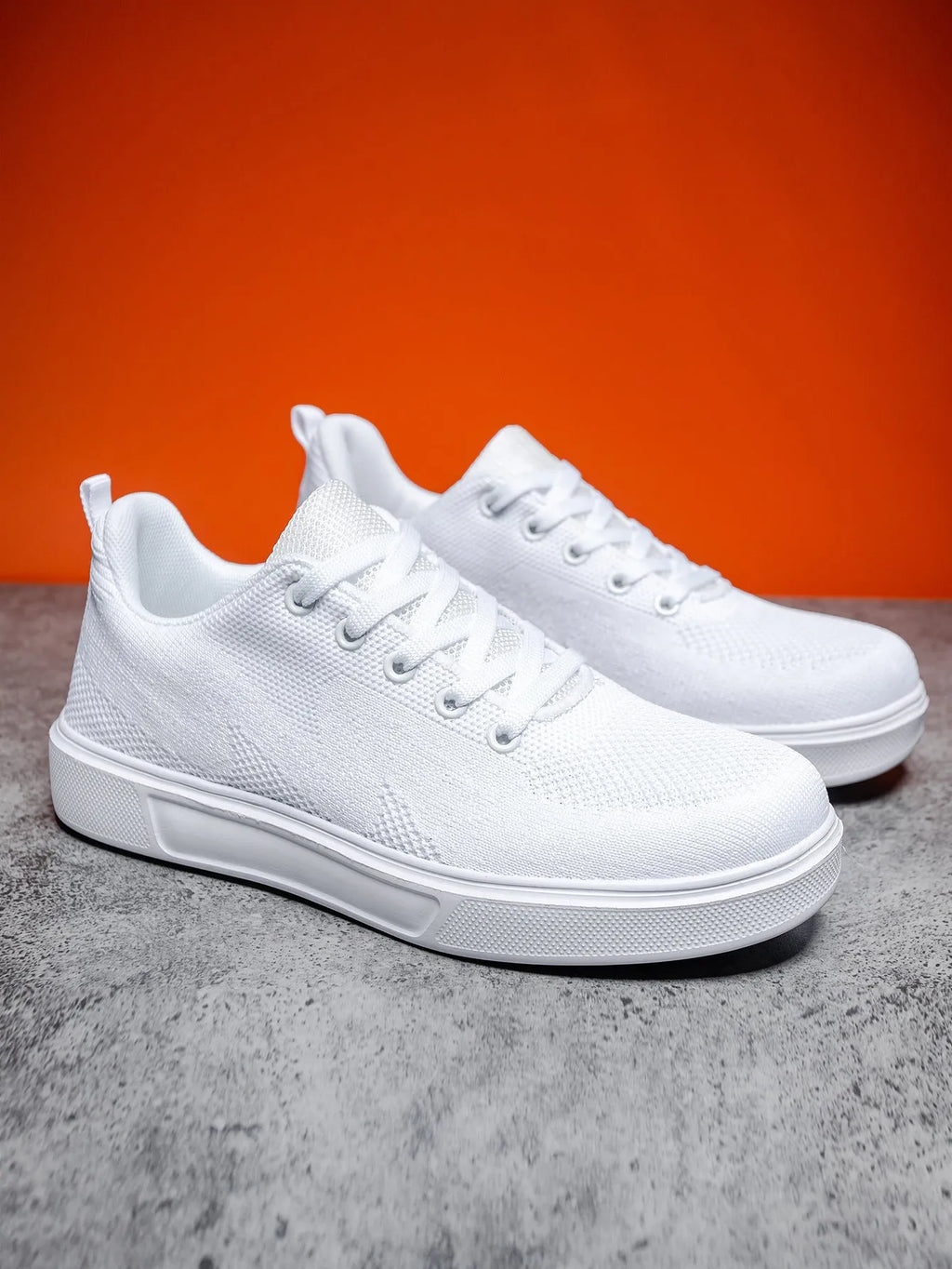 Light white and black unisex casual board shoes with mesh upper and thick EVA sole.