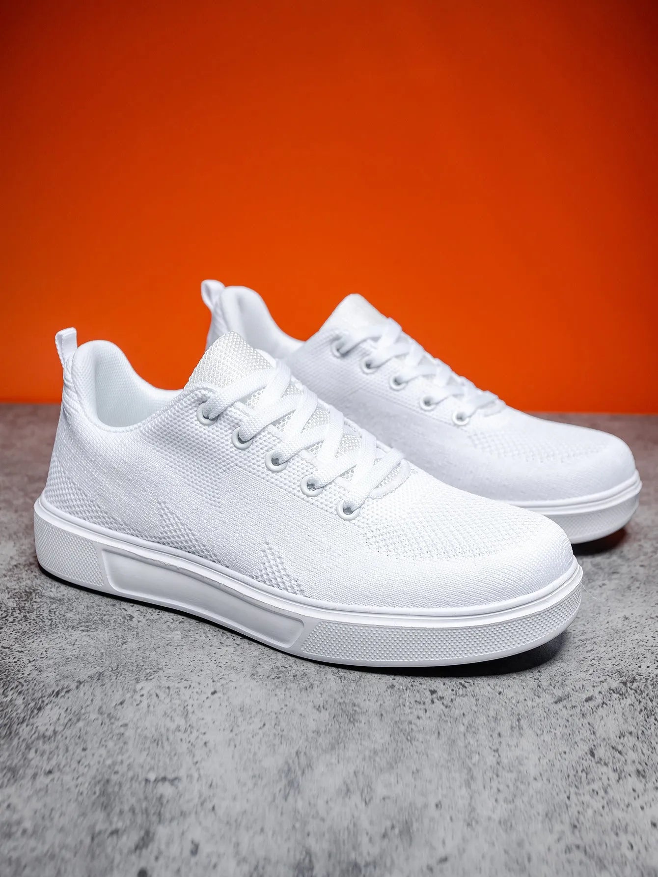 Light white and black unisex casual board shoes with mesh upper and thick EVA sole.