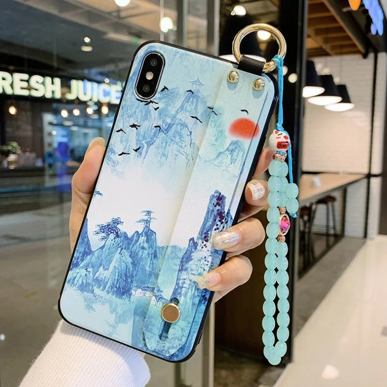 Rose flower design iPhone case with a white wrist strap attached, shown on an iPhone 11.