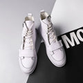 Black and white PU leather men's ankle boots with high-top sneaker design showing microfiber material texture
