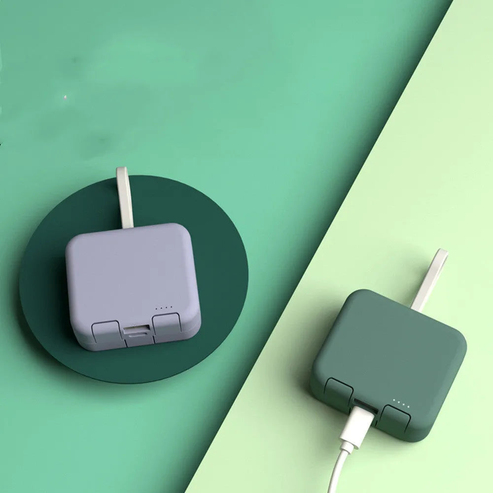 Handbag clip power bank in blue, green, red, or white showing phone stand function and charging ports