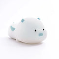 Blue silicone pig-shaped night light with sleeping design and USB charging port