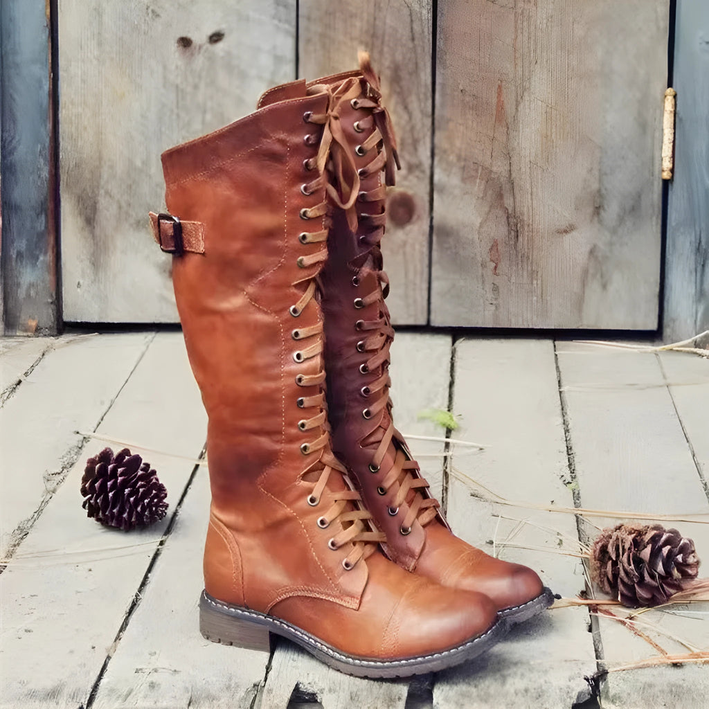 Black women's chunky heel high-leg boots with a round toe and short stout heel on a plain background.