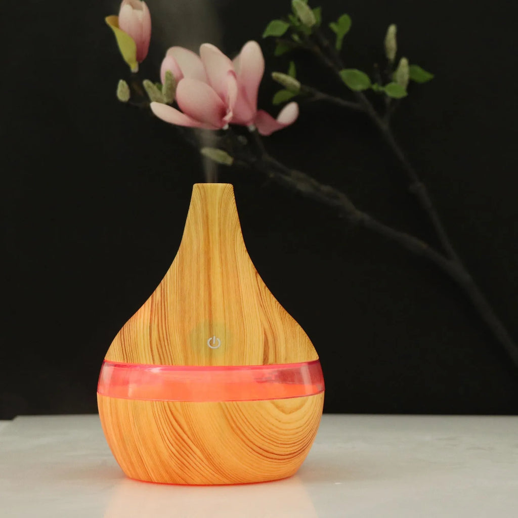 Columnar USB mini air purifier and humidifier in light wood grain finish on a desk.