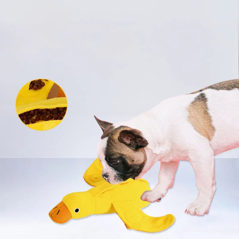 Yellow teddy dog training toy with integrated duck doll and food leak design for scent work