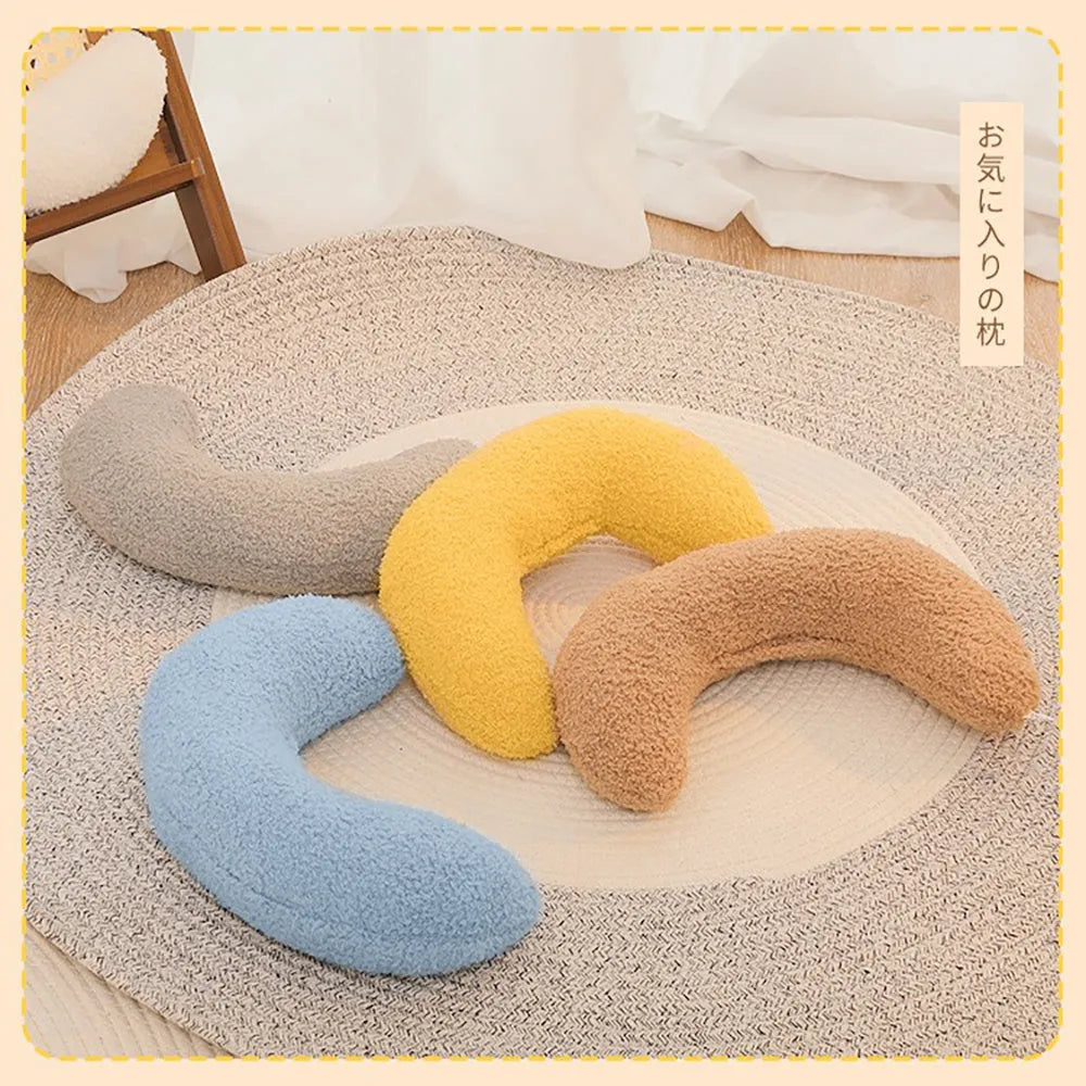 U-shaped blue cat pillow with an adjustable collar, shown on a cat bed.