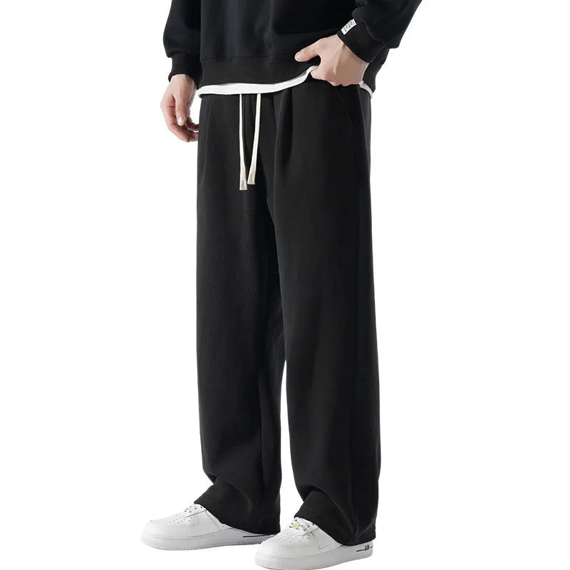 Man wearing apricot coloured loose-fit fleece-lined casual trousers with an elasticated waist.