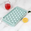 Blue round silicone ice cube tray with lid showing 33 mould cavities