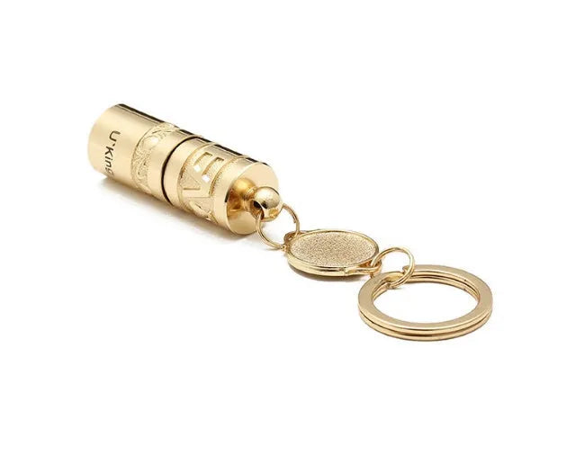 Gold-coloured zinc alloy waterproof mini LED flashlight on a keychain ring.