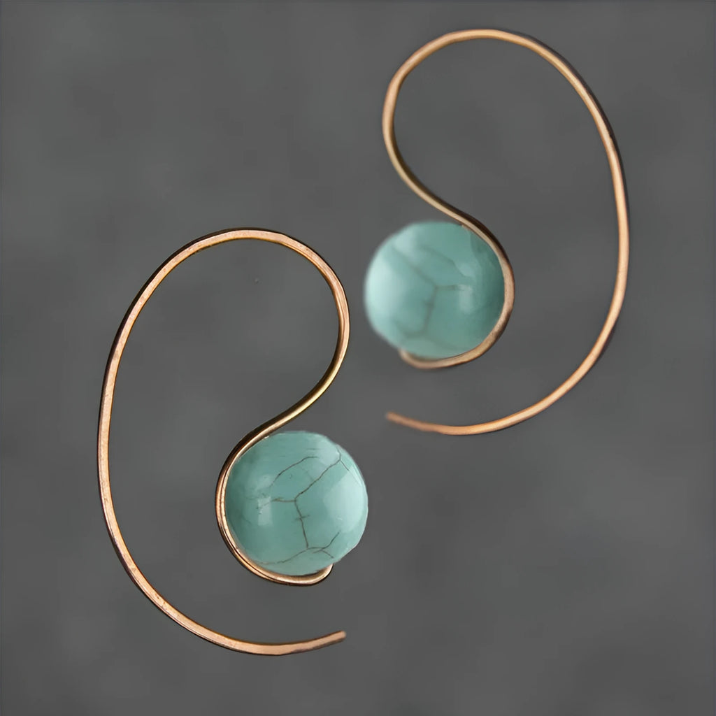 Green turquoise retro style dangle earrings with blue turquoise centrepiece on a white background