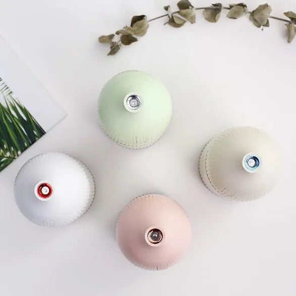 White USB aroma diffuser and humidifier with 300ml tank and LED light on a wooden surface.