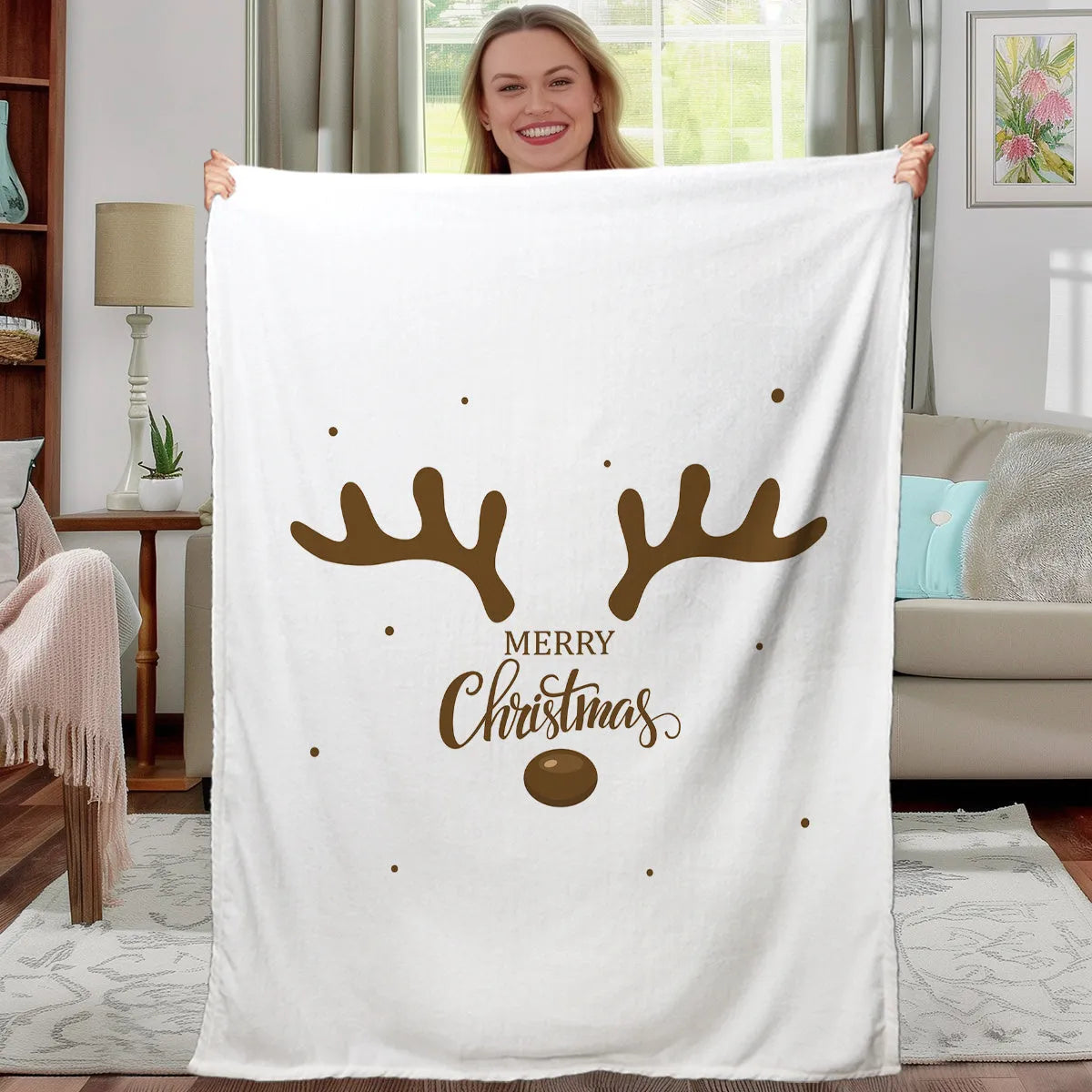 White flannel velvet deer antler pattern Christmas blanket on a sofa