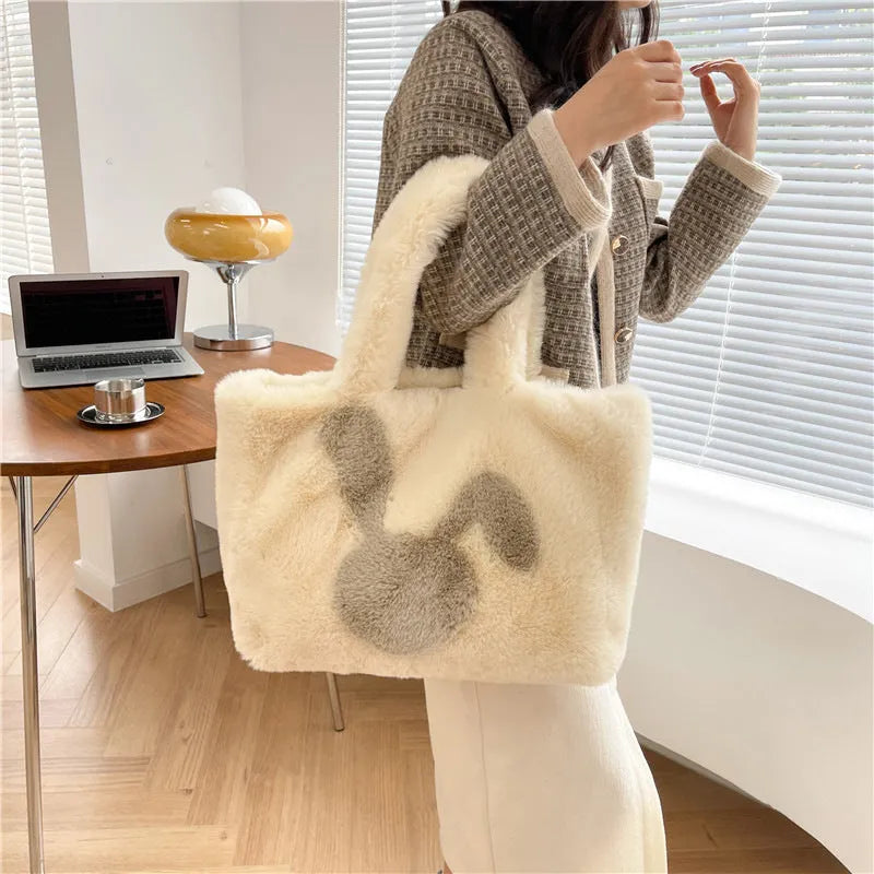 Soft beige plush tote bag with cartoon rabbit ears on the front, shown as a large capacity shoulder bag.