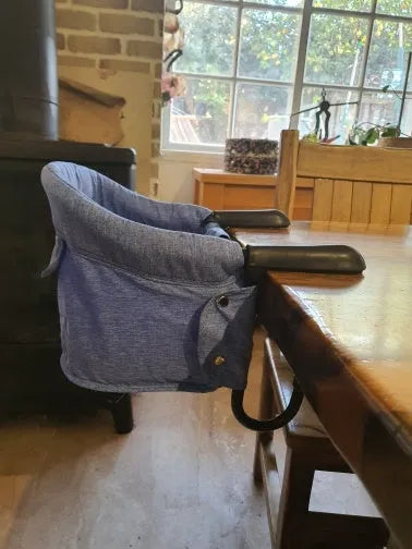 Portable baby dining seat cover with safety belt folded to show compact 42x36x7cm size