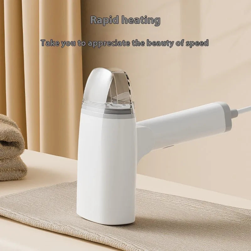 Blue handheld garment steamer unit with water tank and nozzle, showing compact size.