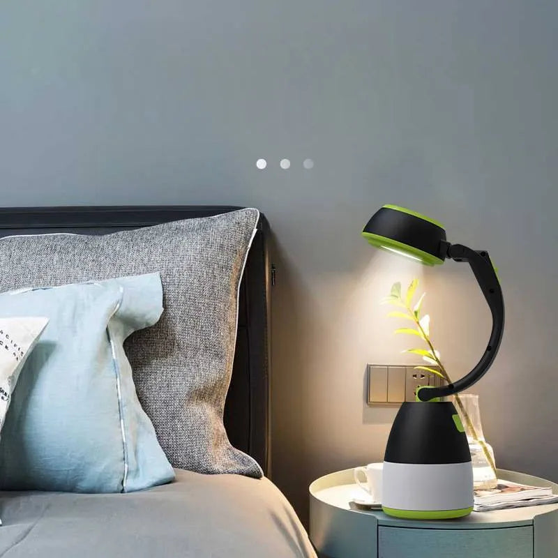 Black green multifunctional LED camping lamp with USB port shown next to a mobile phone.