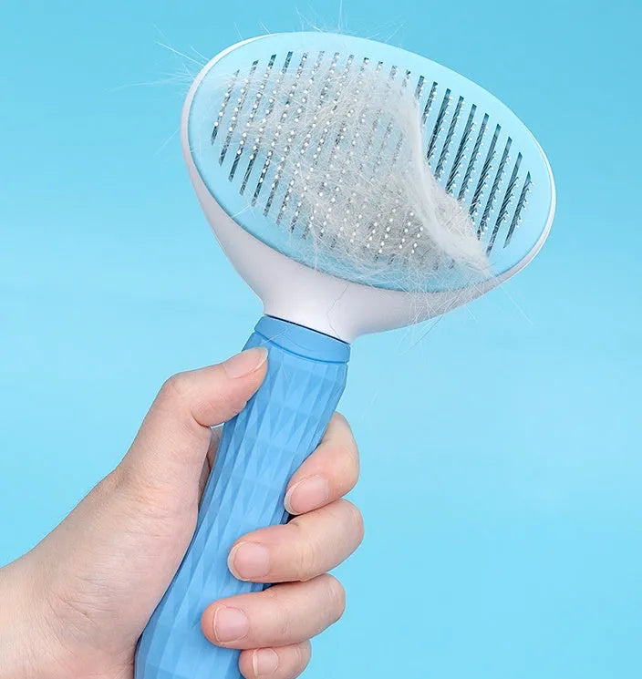 Blue self-cleaning pet comb with fine stainless steel teeth and rubber body on white background