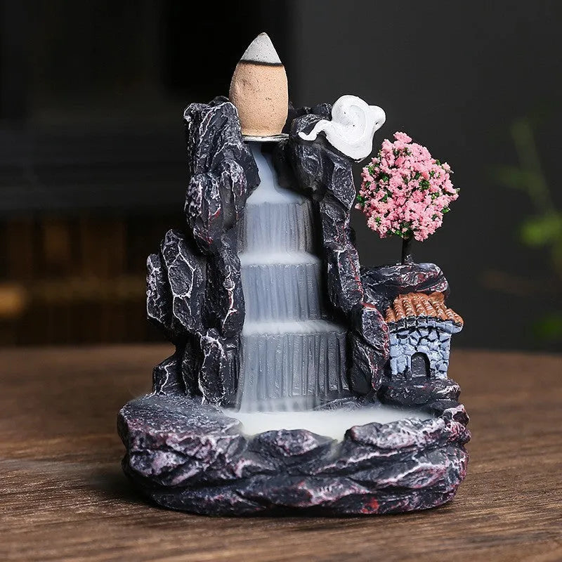 Ceramic backflow incense burner ornament in modern tree design on a table.