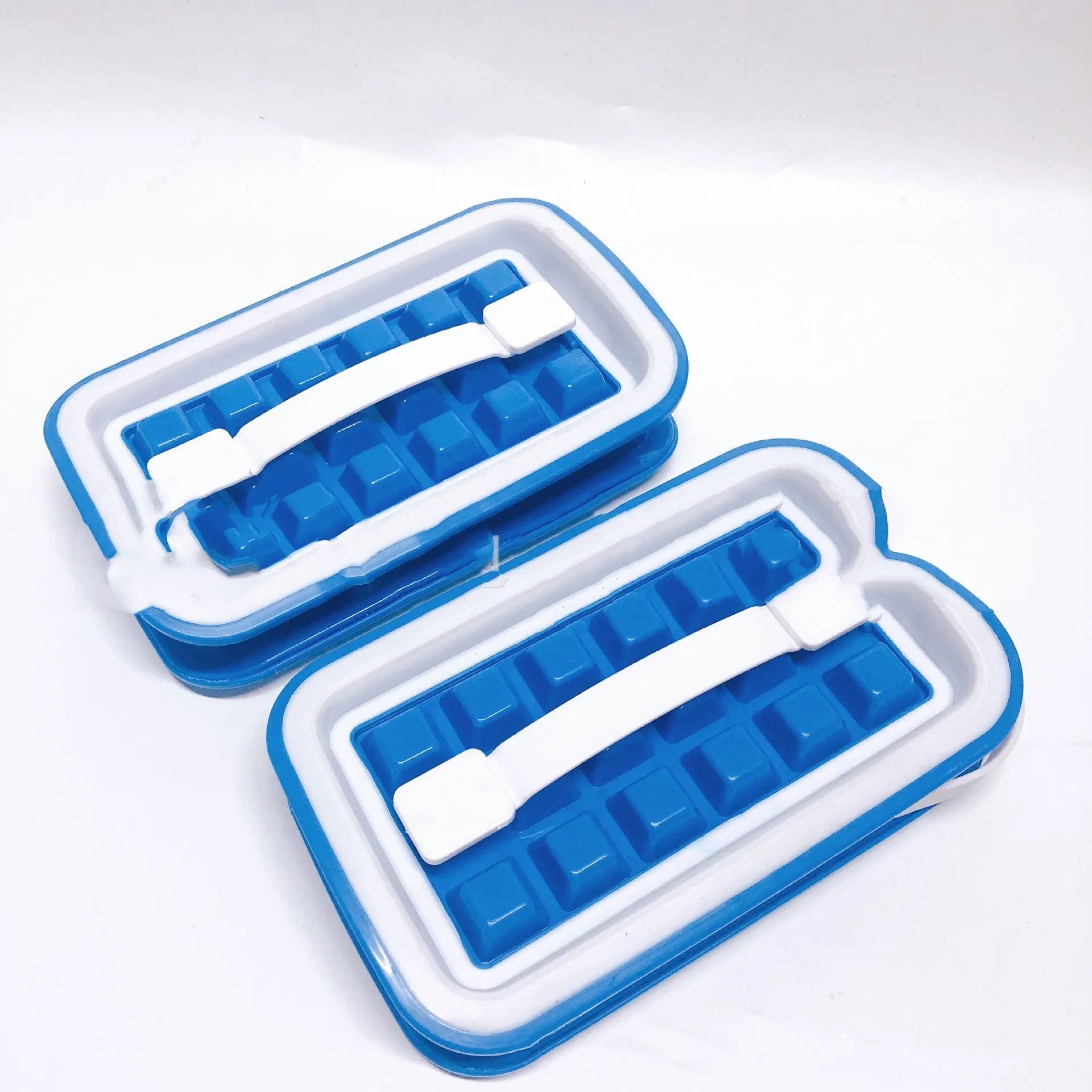 Blue silicone ice cube tray with 36 square cavities and a lid on a wooden table