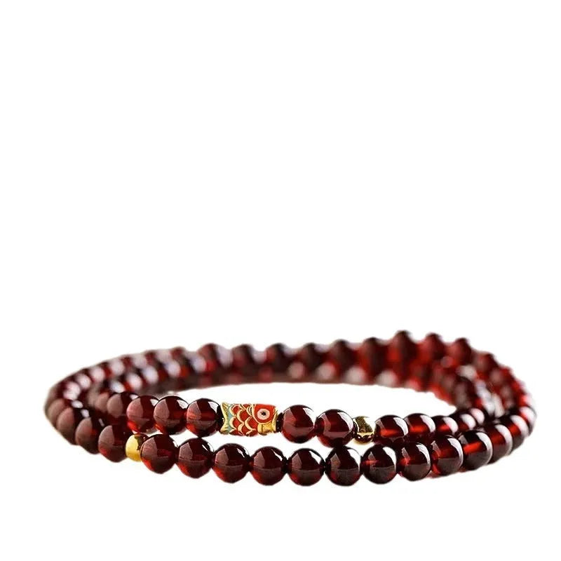 Close-up of a wine red glass bead bracelet showing micro beads and coloured glaze finish.