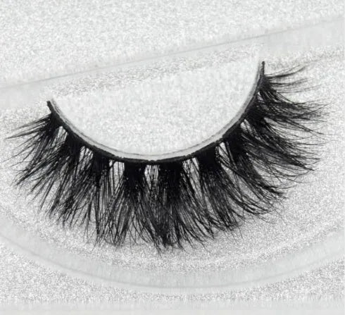 Pair of faux mink eyelashes with long tail and cotton stem against white background