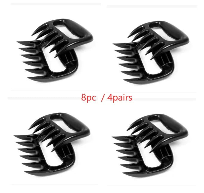Black bear claw meat shredder utensil for pulling pork and chicken on a kitchen surface.