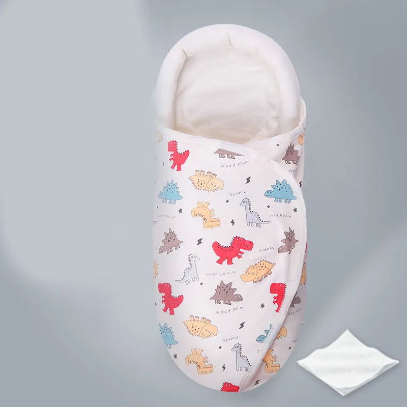 Pure cotton baby swaddle in a dinosaur print, shown laid flat at 30 by 60 cm.