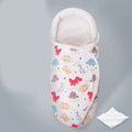 Pure cotton baby swaddle in a dinosaur print, shown laid flat at 30 by 60 cm.