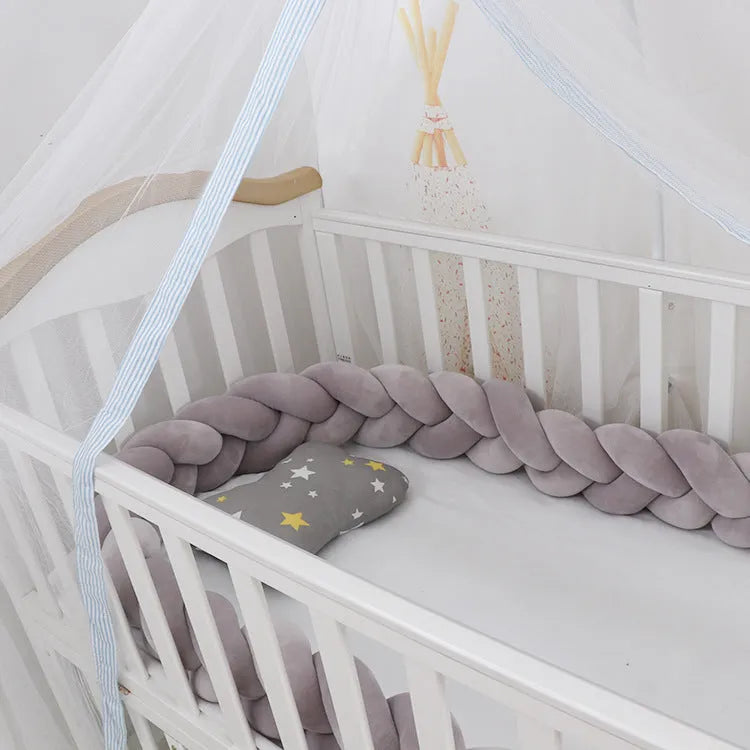 Baby cot bumper braid in spandex crystal velvet, shown in a light grey colour, wrapped around white crib rails.