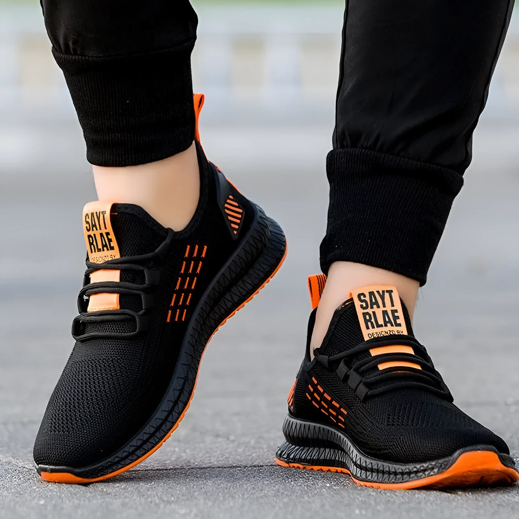 Men's black casual sports shoes with three white stripes and cross-strap detail on the Flying Weave upper.