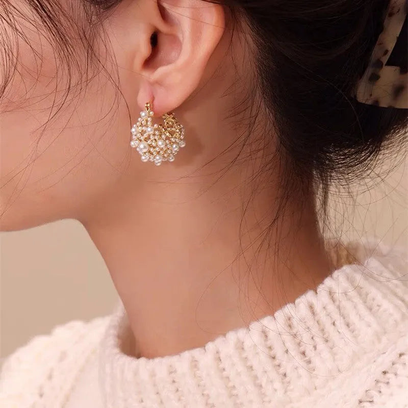 Gold floral basket earrings with pearl inlay and rice-shaped bead construction