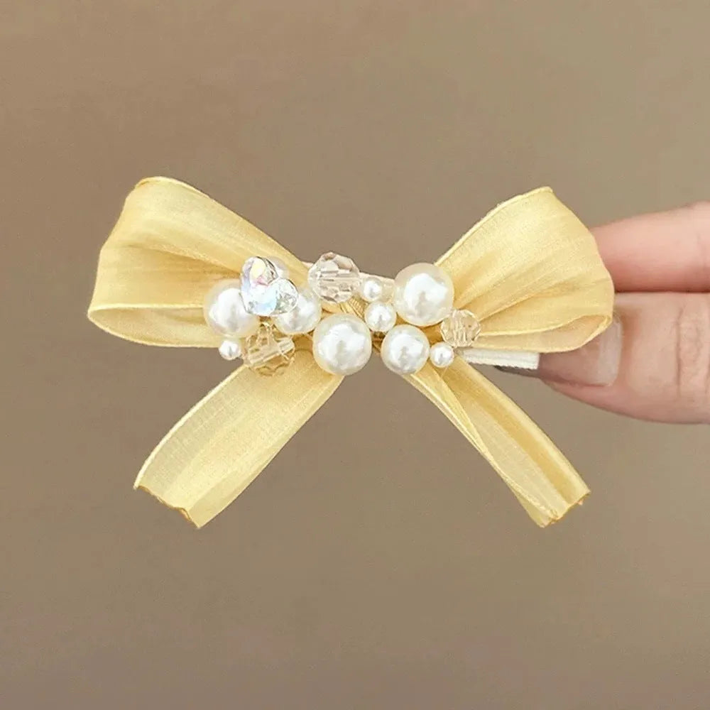 Yellow cloth bow hair clip with rhinestone and pearl decoration on duckbill hair grip