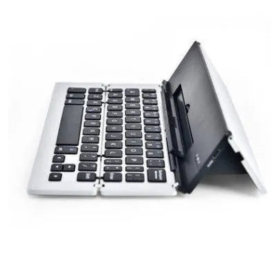 Slim aluminium folding wireless Bluetooth keyboard in four colours, expanded for typing on a flat surface