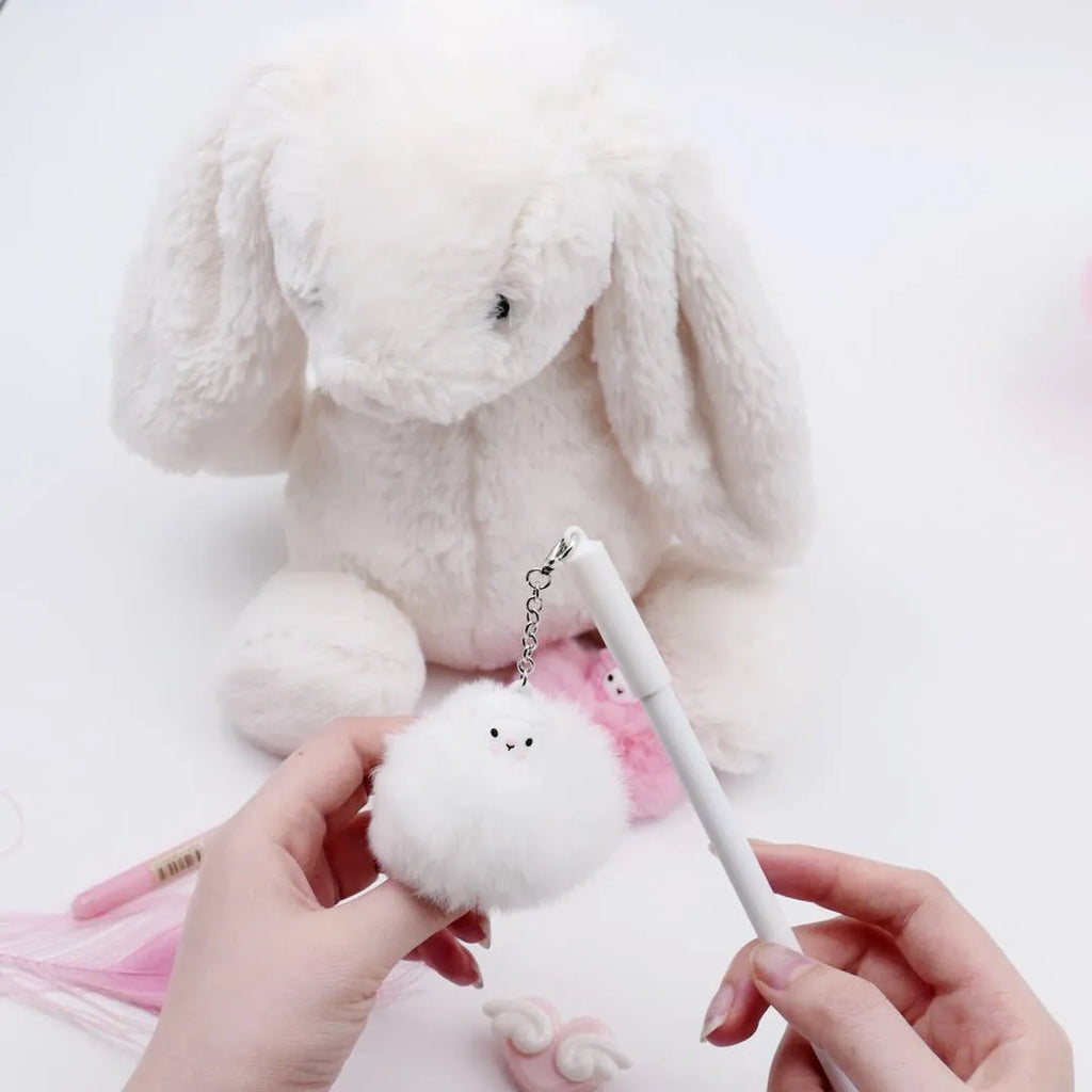 Neutral-coloured plastic ballpoint pen with alpaca hair ball pendant, showing 17cm length and 0.5mm tip.