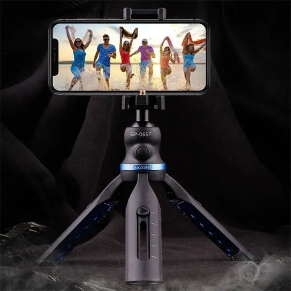 Black plastic and aluminium desktop tripod holding a mobile phone for video calls.