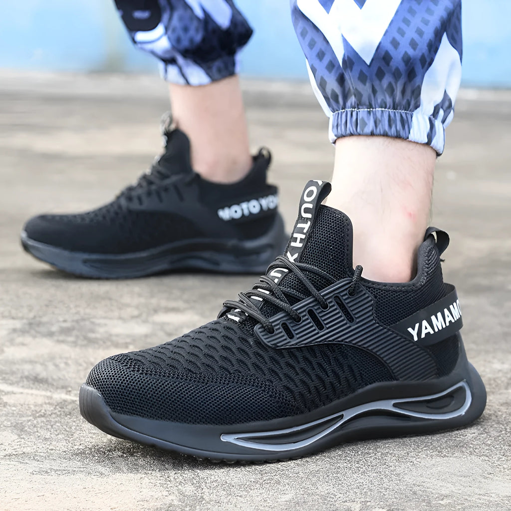 Black ultra-light steel toe anti-piercing work shoes with fly woven upper and low-top design on a white background